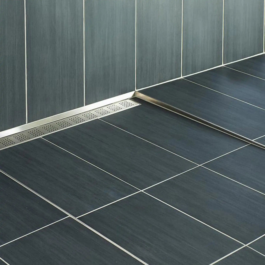 Slope wedge and shower drain made of stainless steel installed in a walk-in shower