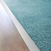 Ambientebild Übergangsprofil verlegt zwischen Laminat und Teppich